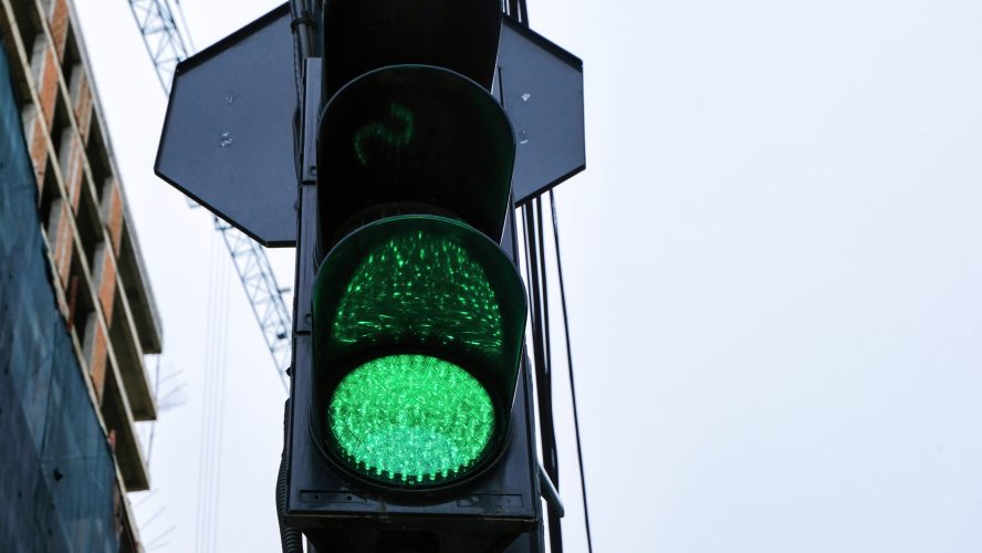 Traffic lights with glowing green one